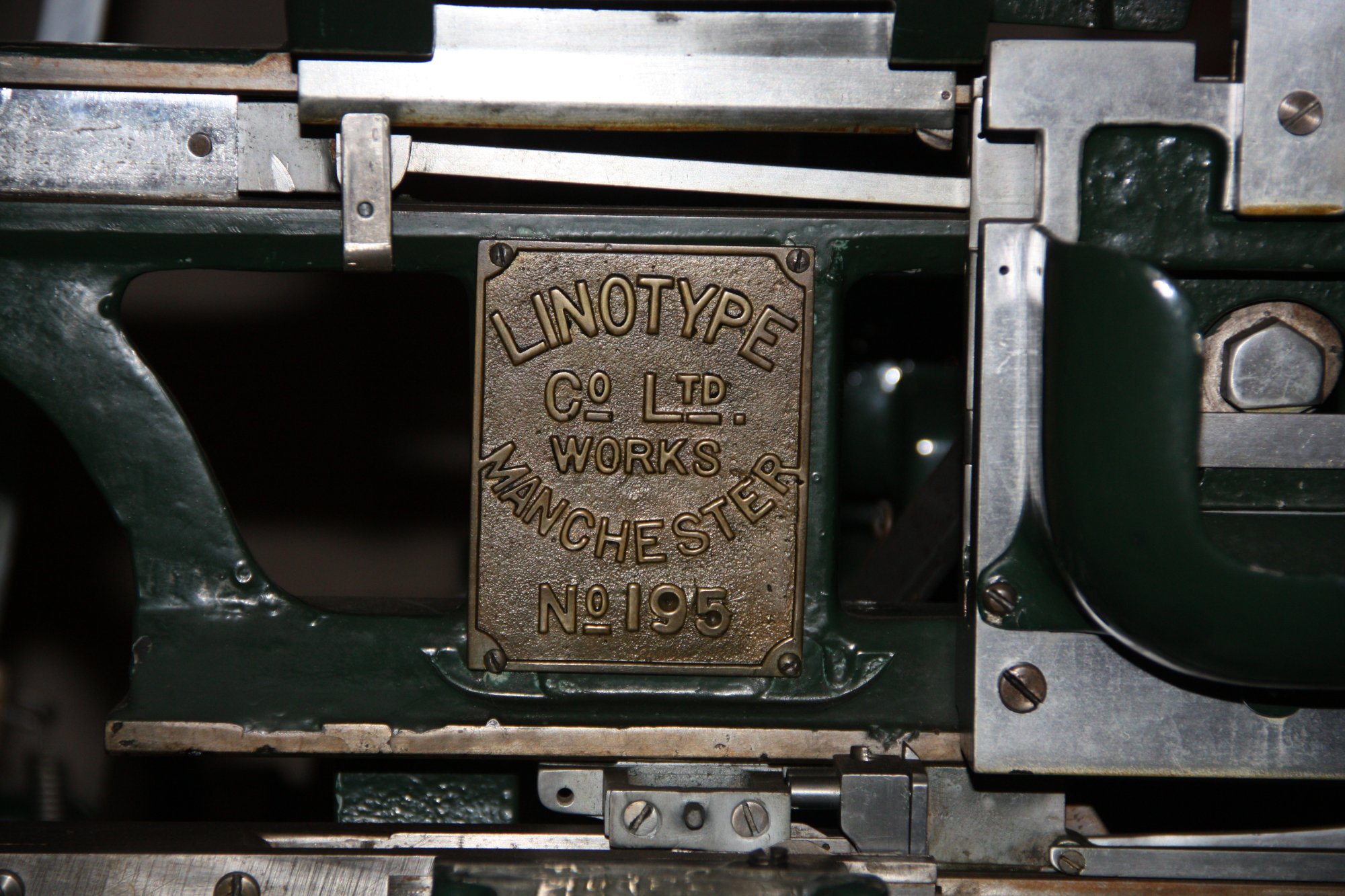 A Linotype machine. The newsroom: where confidence is manufactured daily.